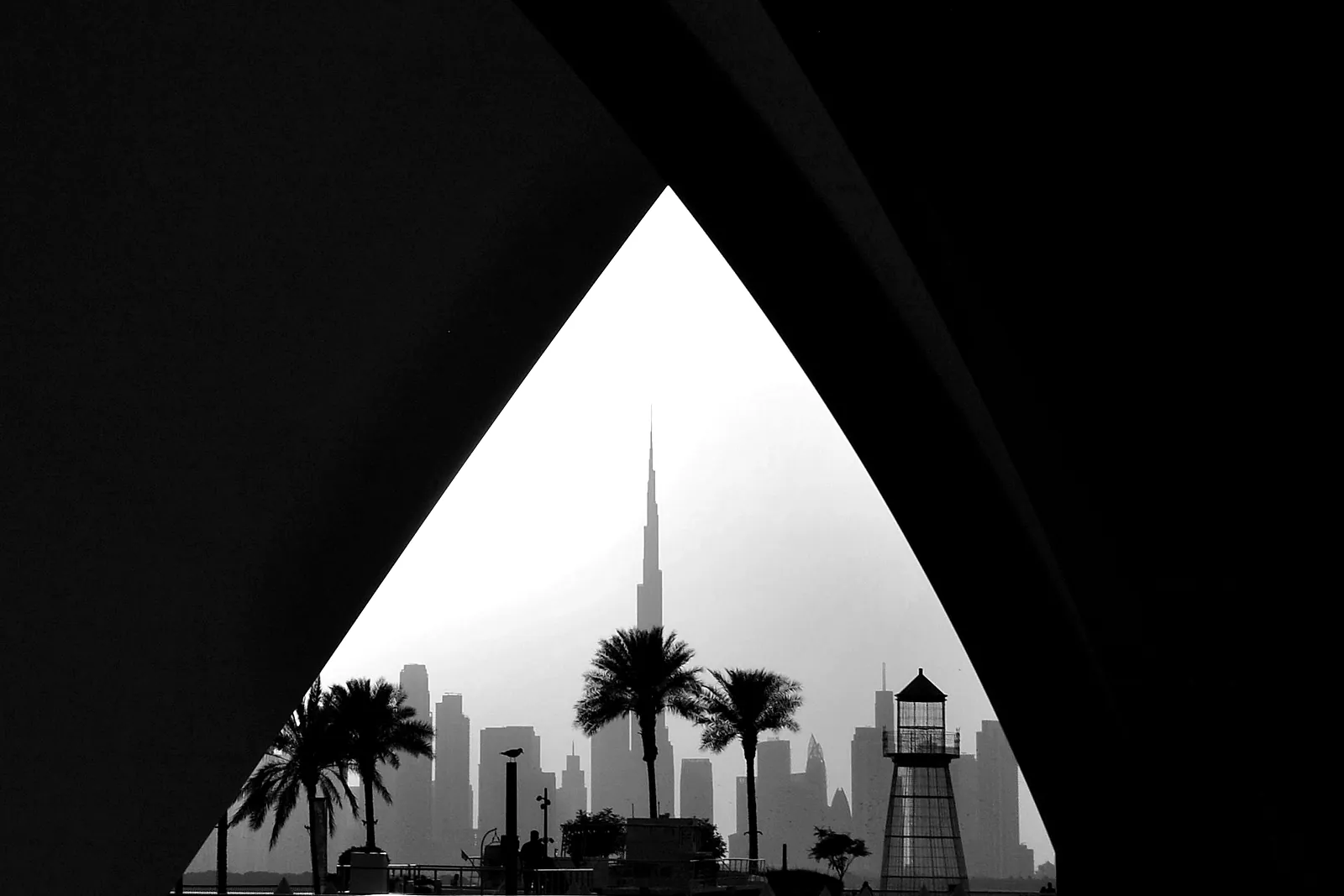 The Dubai skyline framed by an archway at dusk